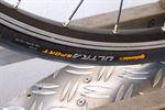 Continental Ultra Sport II Continental Ultra Sport II road bike tire on a rolling resistance test machine